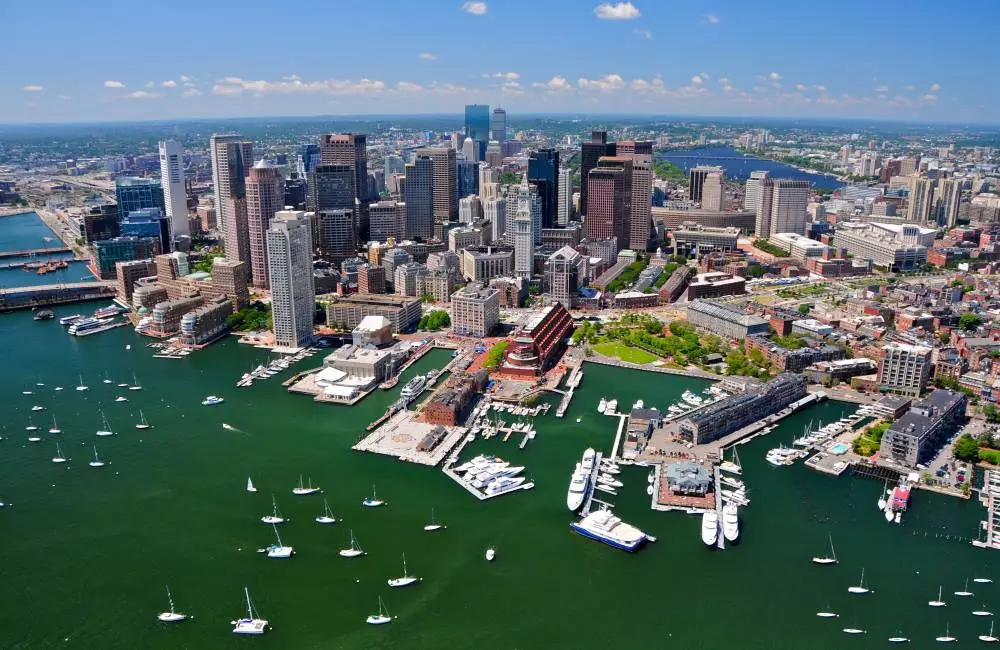 The Boston city skyline against a blue sky.